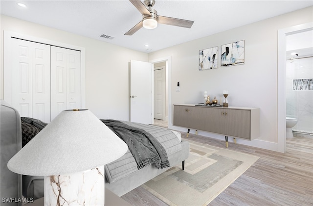 bedroom with ceiling fan, light hardwood / wood-style flooring, ensuite bath, and a closet