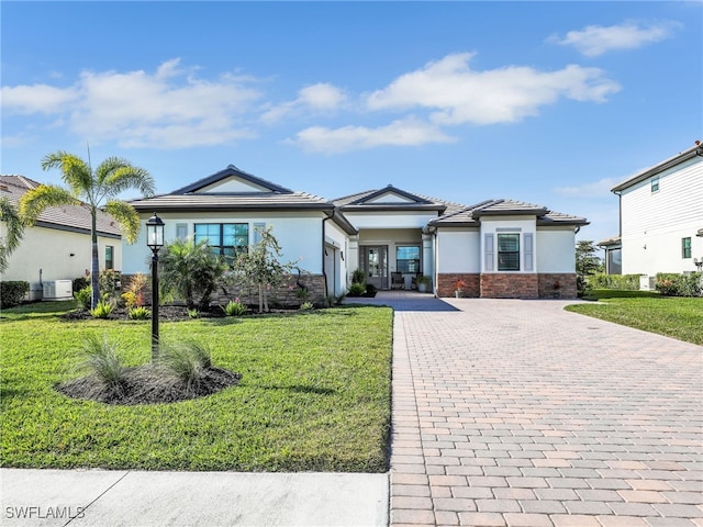 view of front of property with a garage and a front lawn