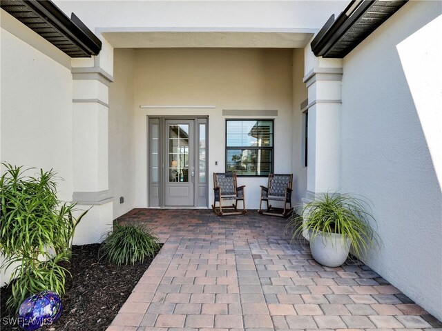 view of exterior entry featuring a patio