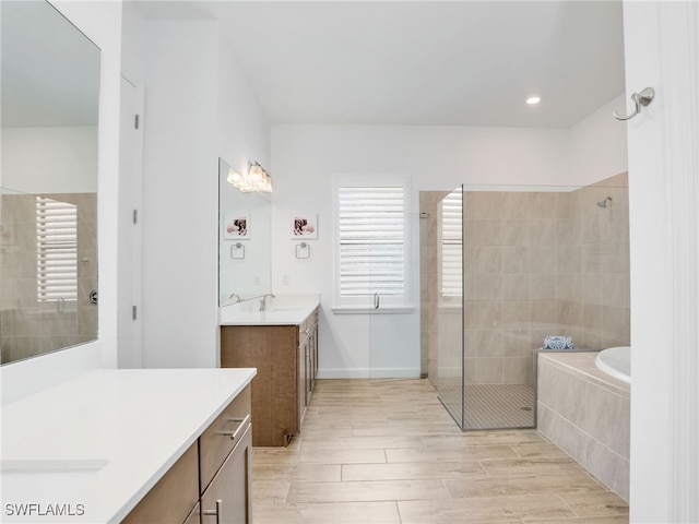 bathroom featuring plus walk in shower and vanity