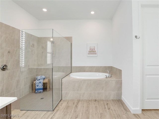 bathroom with independent shower and bath and vanity