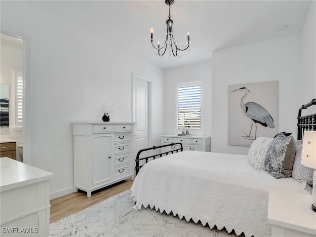 bedroom featuring light hardwood / wood-style floors and a chandelier