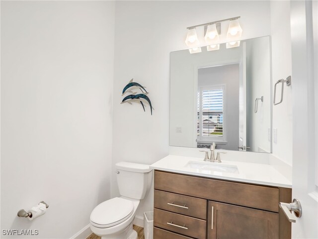 bathroom featuring vanity and toilet