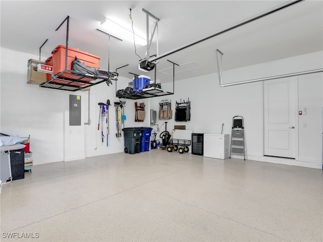 garage with a garage door opener and electric panel