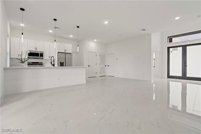 unfurnished living room featuring sink