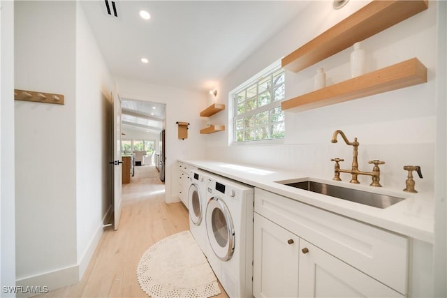 laundry area with plenty of natural light, laundry area, a sink, and washing machine and clothes dryer