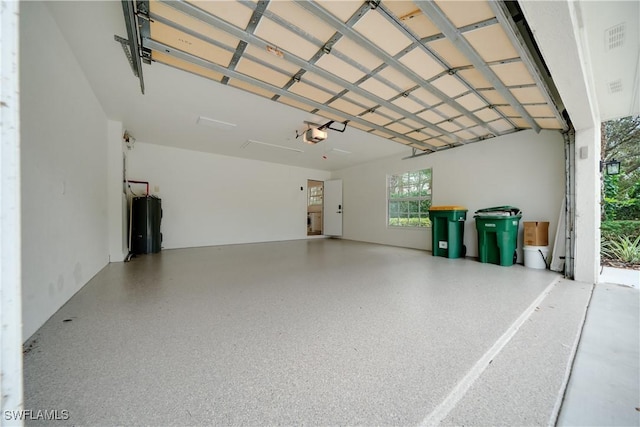 garage featuring water heater and a garage door opener