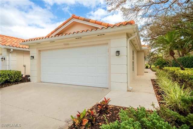 garage with concrete driveway