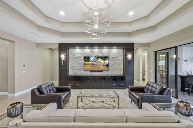 living room with a raised ceiling, light tile patterned floors, and a chandelier