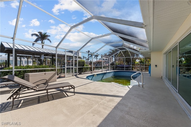 view of swimming pool featuring a patio and glass enclosure