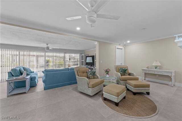 living room with light tile patterned floors, crown molding, and ceiling fan