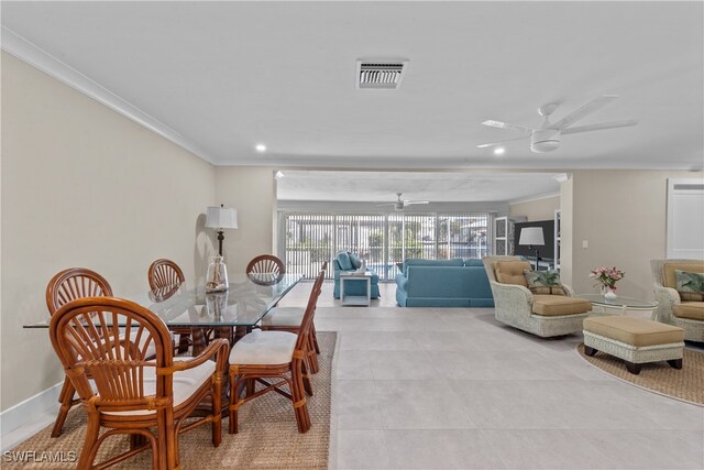 dining area featuring ornamental molding, light tile patterned floors, and ceiling fan