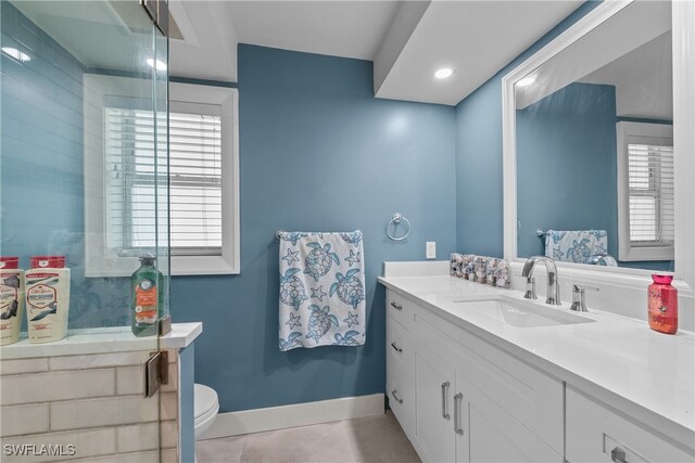 bathroom with vanity, tile patterned flooring, and toilet