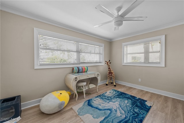 game room with ceiling fan, crown molding, and light hardwood / wood-style floors