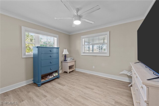 interior space featuring ceiling fan, ornamental molding, light hardwood / wood-style flooring, and a wealth of natural light