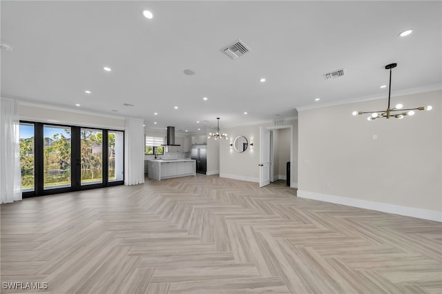 unfurnished living room with light parquet floors, ornamental molding, a chandelier, and french doors