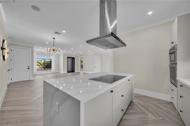 kitchen featuring white cabinetry, black electric stovetop, light parquet flooring, and island exhaust hood