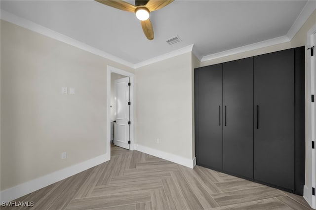 unfurnished bedroom with crown molding, ceiling fan, a closet, and light parquet floors