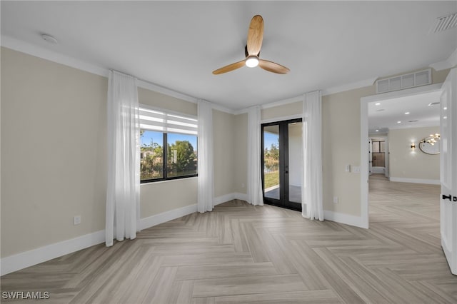 empty room with light parquet flooring, ceiling fan, and french doors