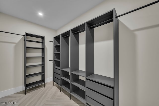 spacious closet featuring light parquet flooring