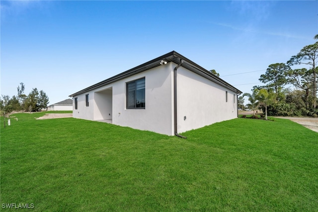 view of side of property with a lawn