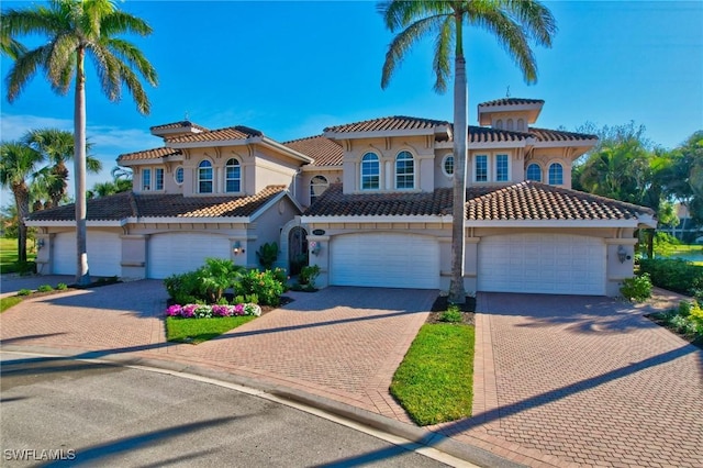 mediterranean / spanish-style home with a garage