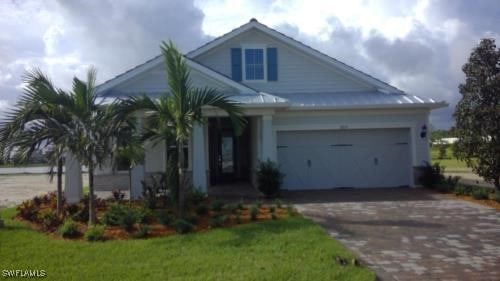 view of front of home featuring a garage and a front yard