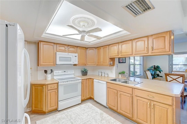 kitchen with sink, white appliances, ceiling fan, kitchen peninsula, and light brown cabinets