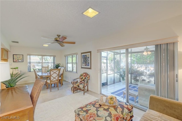 interior space featuring ceiling fan, a healthy amount of sunlight, and a textured ceiling