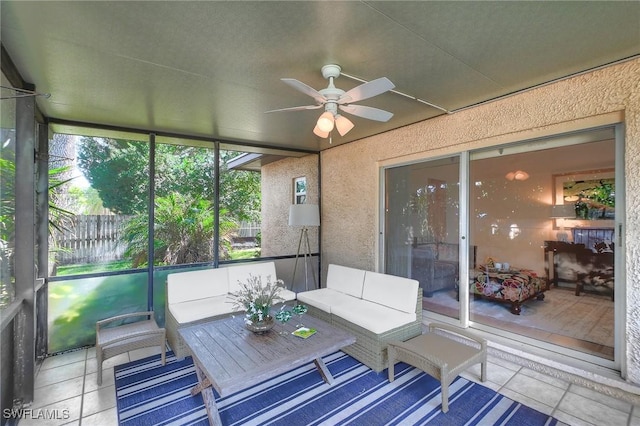 unfurnished sunroom with ceiling fan