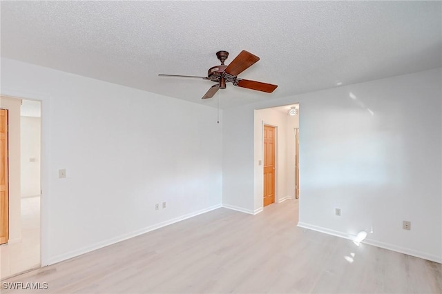 spare room featuring ceiling fan, a textured ceiling, and light hardwood / wood-style flooring