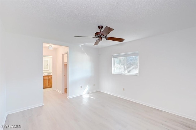 unfurnished room with ceiling fan, a textured ceiling, and light hardwood / wood-style flooring