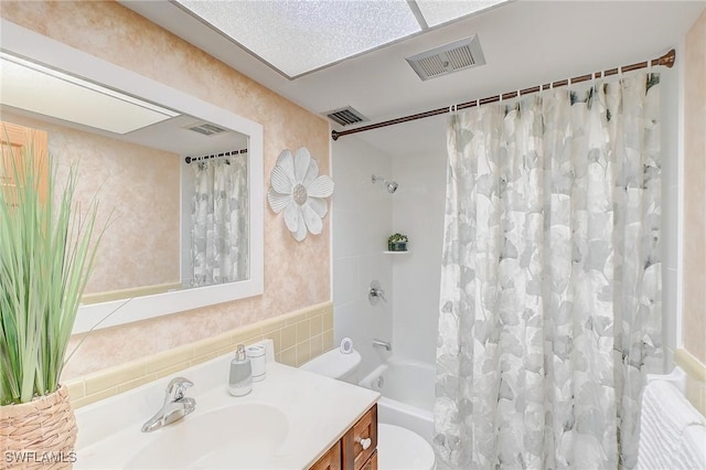 full bathroom with vanity, toilet, and shower / bath combo with shower curtain