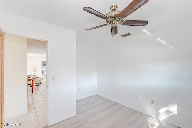 empty room featuring ceiling fan and light wood-type flooring