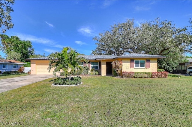 ranch-style house featuring an attached garage, concrete driveway, and a front yard