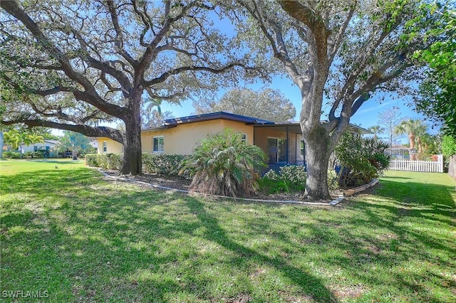 view of side of property featuring a yard