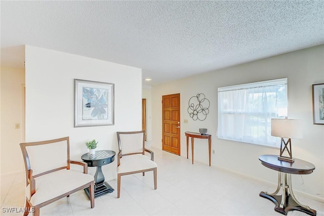 living area featuring a textured ceiling