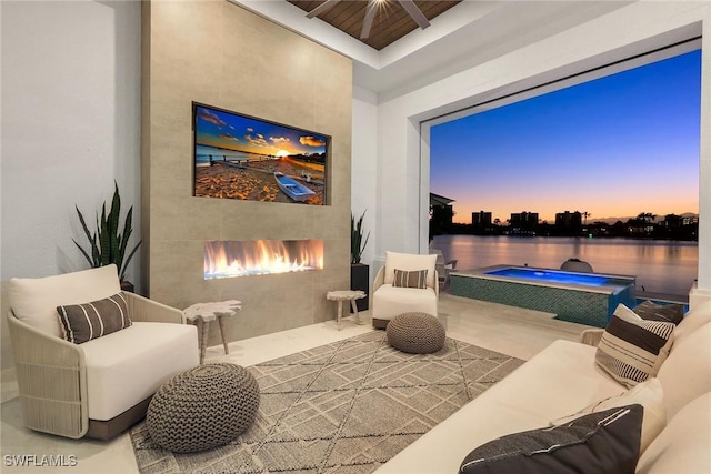 sitting room featuring a fireplace and a water view