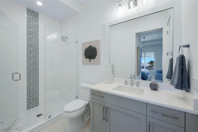 bathroom with vanity, toilet, and a shower with shower door