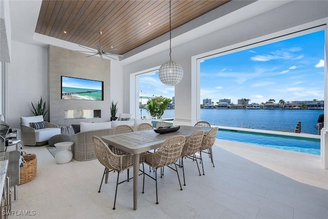 dining area with wooden ceiling, a raised ceiling, and ceiling fan