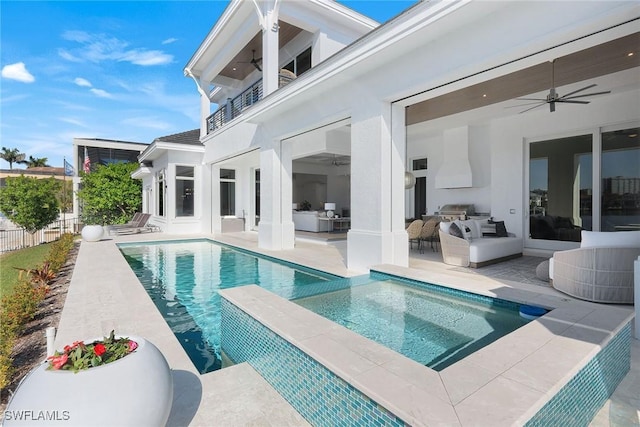 view of pool with an outdoor living space, a patio area, and ceiling fan