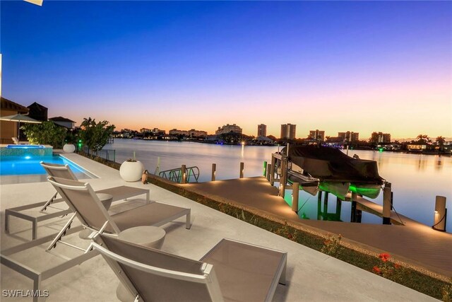 exterior space with a patio, a water view, and a dock