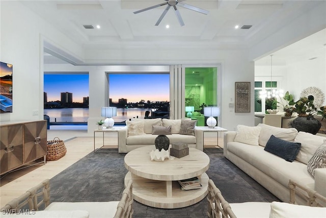 living room with coffered ceiling, beam ceiling, dark hardwood / wood-style floors, and a water view