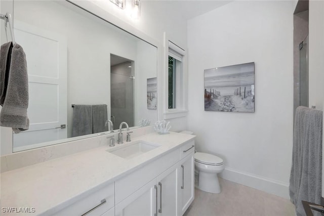 bathroom with vanity, toilet, and a shower with shower door