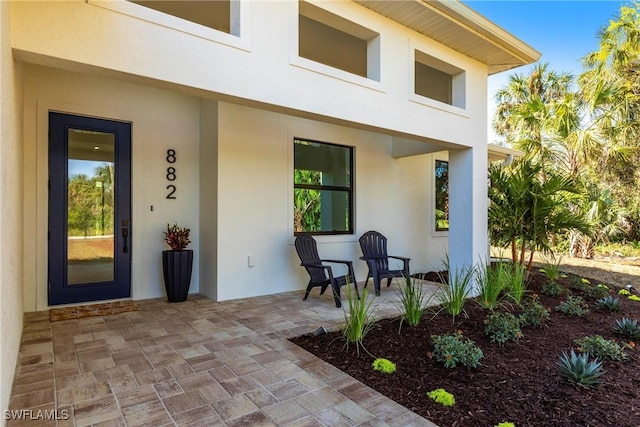 property entrance featuring a patio