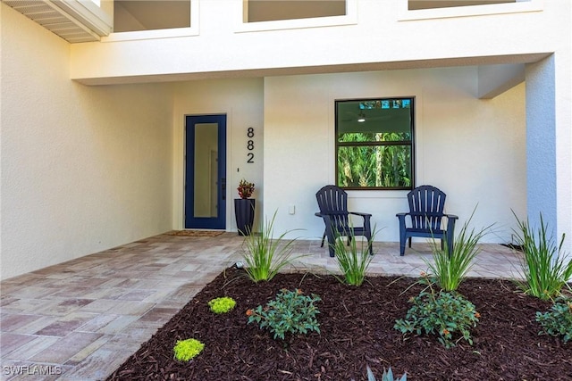 entrance to property featuring a patio