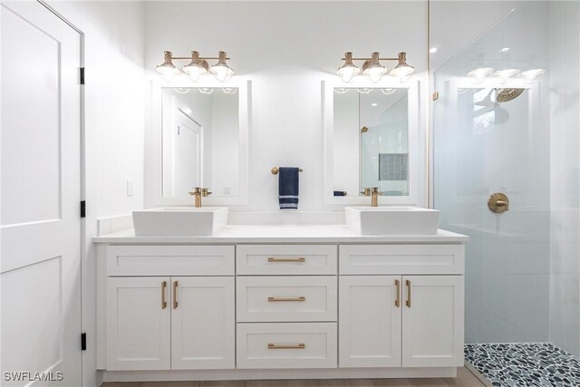 bathroom featuring a shower and vanity