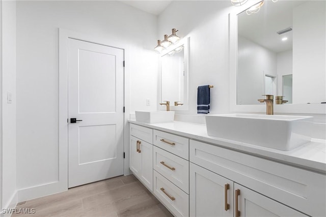 bathroom featuring vanity and hardwood / wood-style floors