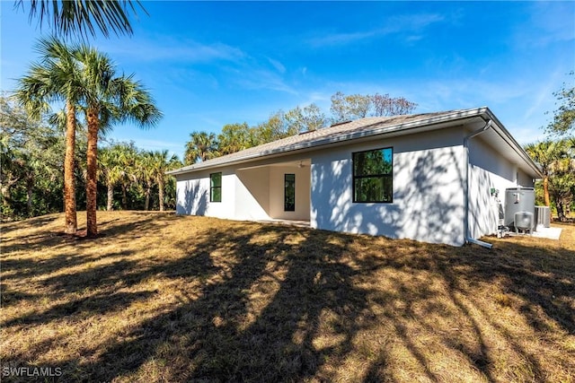 back of house with a lawn