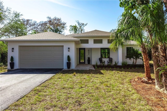 view of front of home featuring a garage and a front lawn